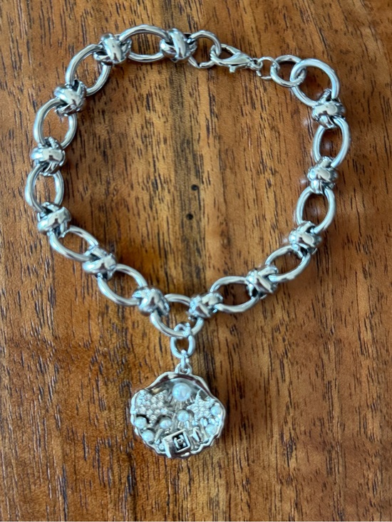 Chanel. Jewelry - ChaneI Silver-Tone Charm Link Bracelet with Silver Clam Shell of Embellishments.